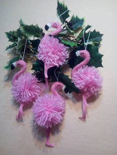 some pink flamingos are hanging on the wall