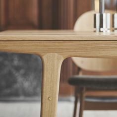 a wooden table with two chairs next to it