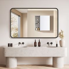 a bathroom with two sinks and a large mirror on the wall over it's counter