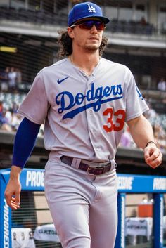 a dodgers baseball player is walking on the field