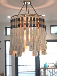 a chandelier with tassels hanging from it's sides in a living room