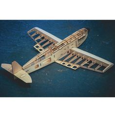 a wooden model of an airplane on the water