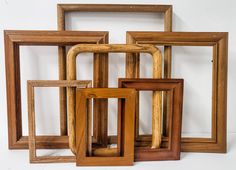 five wooden frames are stacked on top of each other in different sizes and shapes,