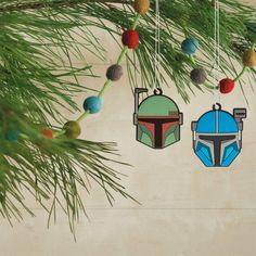 star wars themed ornaments hanging from a pine tree in the shape of boba fett