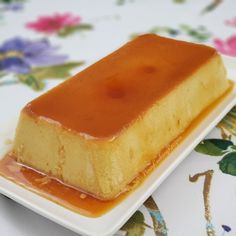 a piece of cake sitting on top of a white plate covered in caramel sauce