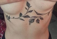 a woman's chest with leaves on it and the bottom part of her stomach