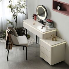 a white desk with a mirror, chair and potted plant in the corner next to it