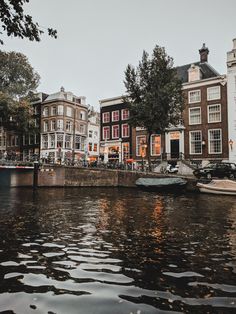 boats are parked on the water in front of some buildings