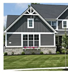 a large gray house with white trim and windows