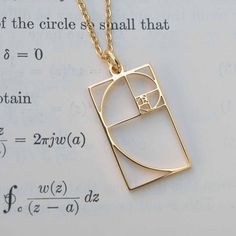 "The Fibonacci sequence, also known as the golden rectangle, is the basis for some of nature's most amazing creations. Besides being useful for art, architecture, financial market analysis, and various data algorithms, it is also spectacularly beautiful. This exquisite, gold or silver colored steel Fibonacci pendant measures 1\" by 5/8\" and is hung from your choice of an 18\" gold plated, sterling silver or non-tarnishing steel chain.  Perfect for: * Mathematicians, scientists, number lovers * Science Inspired Jewelry, Ratio Math, Fibonacci Necklace, Golden Rectangle, Fibonacci Sequence, Fibonacci Spiral, Science Jewelry, Spiral Necklace, Market Analysis