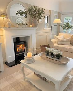 a living room filled with furniture and a fire place next to a couch in front of a fireplace