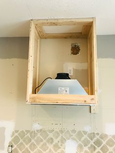 an open box on the wall with some electrical wires in it