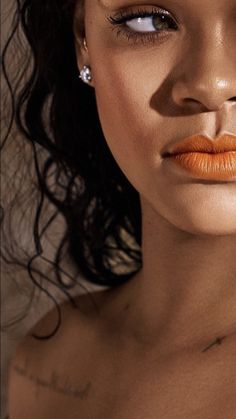 a woman with orange lipstick on her face