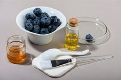 blueberries, honey, and other ingredients sit on a table