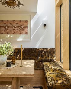 a living room with a couch, table and flowers in vases on the coffee table