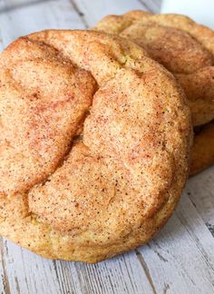 three cookies sitting on top of a white wooden table