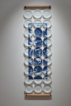 a blue and white plate display on a wall