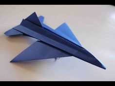 an origami fighter jet sitting on top of a table