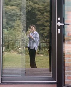 a man standing in front of a glass door