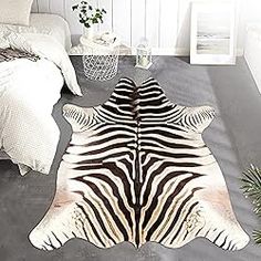 a zebra print rug on the floor in a bedroom