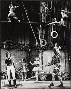 an old black and white photo of people on stage with circus performers in the background