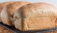 two loaves of bread sitting on a cooling rack