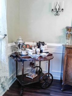 an old fashioned cart is in the corner of a room with white walls and wood floors