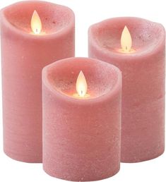 three pink candles sitting next to each other