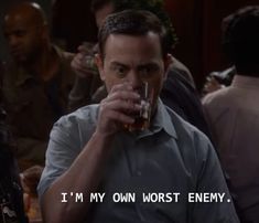 a man drinking from a glass in front of other people at a bar with the caption i'm my on worst enemy