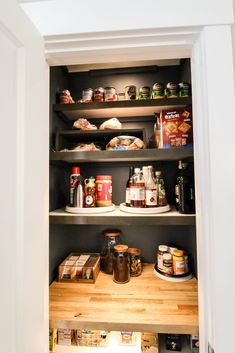 an open pantry with food items on the shelves