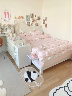 a bedroom with a bed, desk and chair in the corner is decorated in pastel pinks