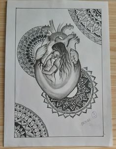 a drawing of a human heart on a piece of paper with an intricate border around it