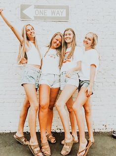 three girls standing in front of a one way sign