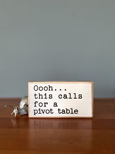 a wooden sign that says oooh this calls for pivot table on it