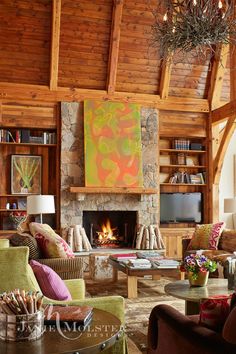 a living room filled with furniture and a fire place in the middle of a room