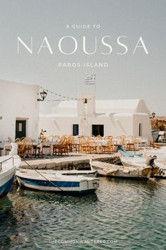 boats are docked in the water next to a building with tables and chairs on it