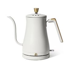 a white coffee pot with a gold handle on the top and bottom, in front of a white background