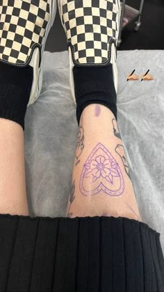 a person's legs with tattoos on them