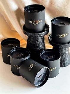 several black cups are stacked on top of each other, with the word agabo printed on them