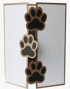 an open card with two paw prints on the front and one paw print on the back