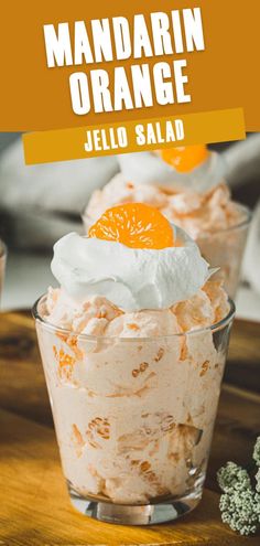 mandarin orange jello salad in a glass dish with whipped cream and an orange slice on top