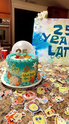 a birthday cake sitting on top of a table next to a sign that says 25 year later late