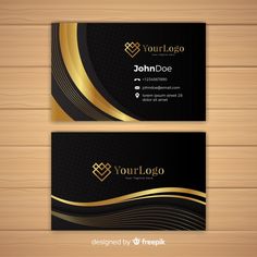 black and gold business card on wooden background