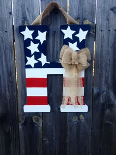 an american flag letter hanging on a fence