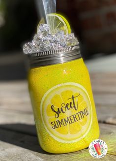 a mason jar filled with lemonade and ice sitting on top of a wooden table