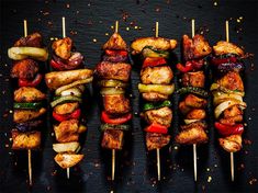 several skewers of meat and vegetables on sticks