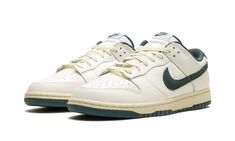 The Nike Dunk Low "Athletic Department - Deep Jungle" is a colorway of the retro basketball sneaker with a vintage college sports aesthetic.  The upper features a Sail leather construction with a Deep Jungle-colored suede Swoosh that matches the appearance of the heel tab with “Nike” embroidery.  Classic “Nike” detailing can be seen on the tongue.  More Deep Jungle accenting includes a green lining, and green rubber outsole underneath the rubber midsole.  A special “Nike Athletic Department” logo is found on each insole.  Release date: October 1, 2023 Vintage Nike Shoes Aesthetic, Nike Shoes Green, Casual Shoes For Men Sneakers, Shoes Nike Dunks, Vintage Nike Shoes, Green Nike Shoes, Nike Embroidery, Deep Jungle, Sneakers Box