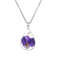 a purple flower in a tear shaped pendant