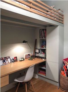 a loft bed with desk underneath it and bookshelf above the bed in front of it