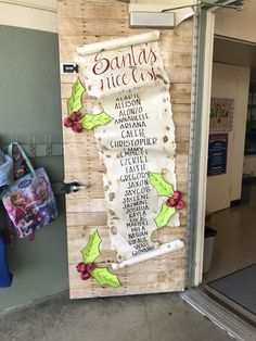 the door to santa's nice shop is decorated with holly and mists on it